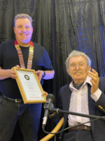 President Mike Harris presenting Mark Raffles with his induction into the Hall of Fame certificate